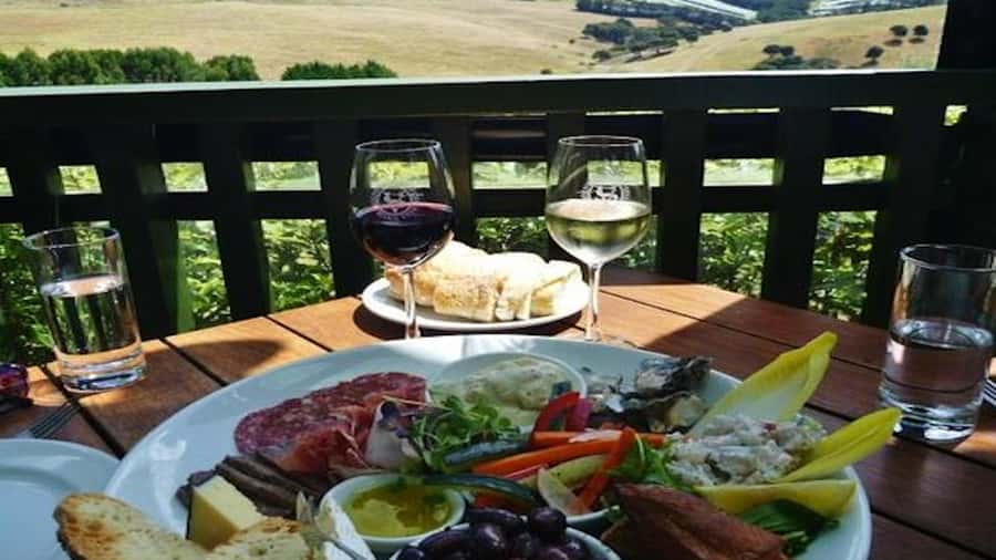 Waiheke: Scenic Taste and Graze Tour with Wine, Whisky, Beer - Mudbrick Vineyard and the first glass of Waiheke wine